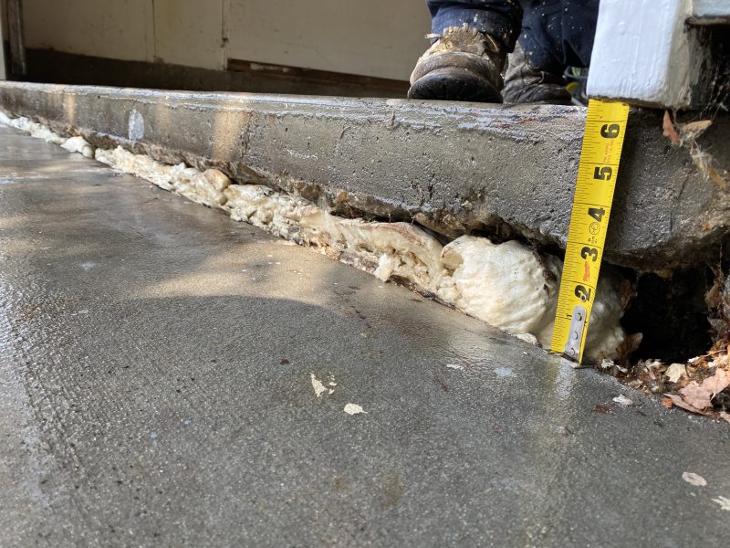 settled garage floor and driveway slab edge (image 1)