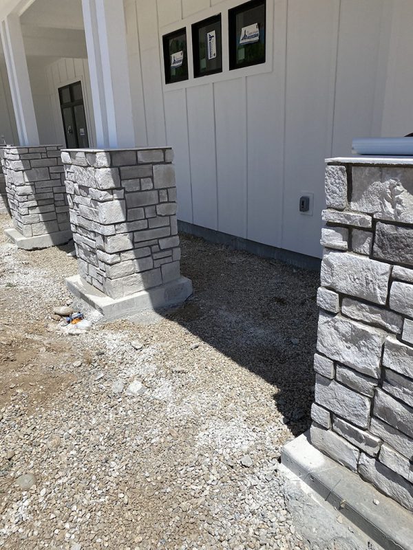 Stone-clad porch columns beside the house