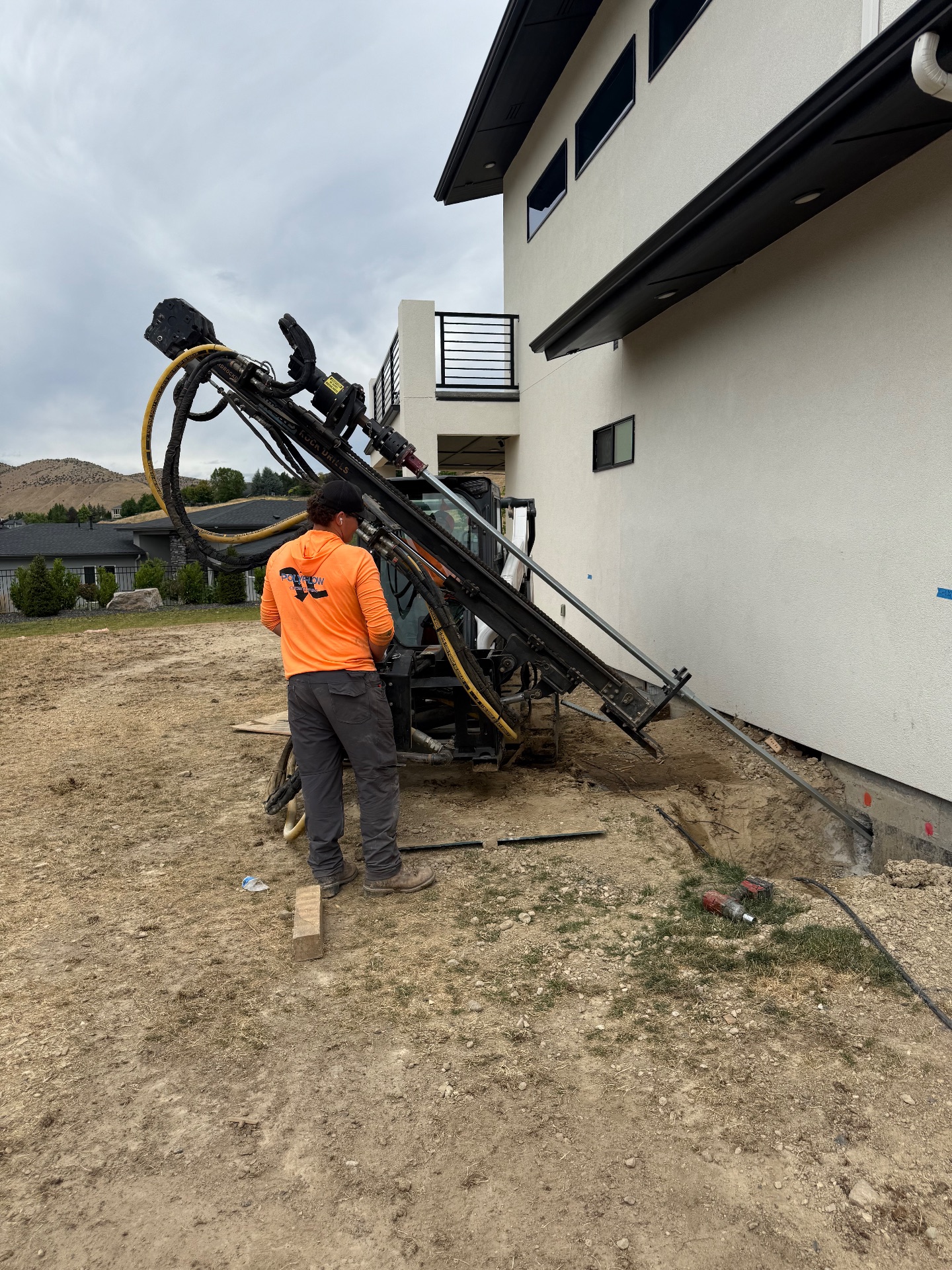 Installing helical tiebacks with our drill rig.
