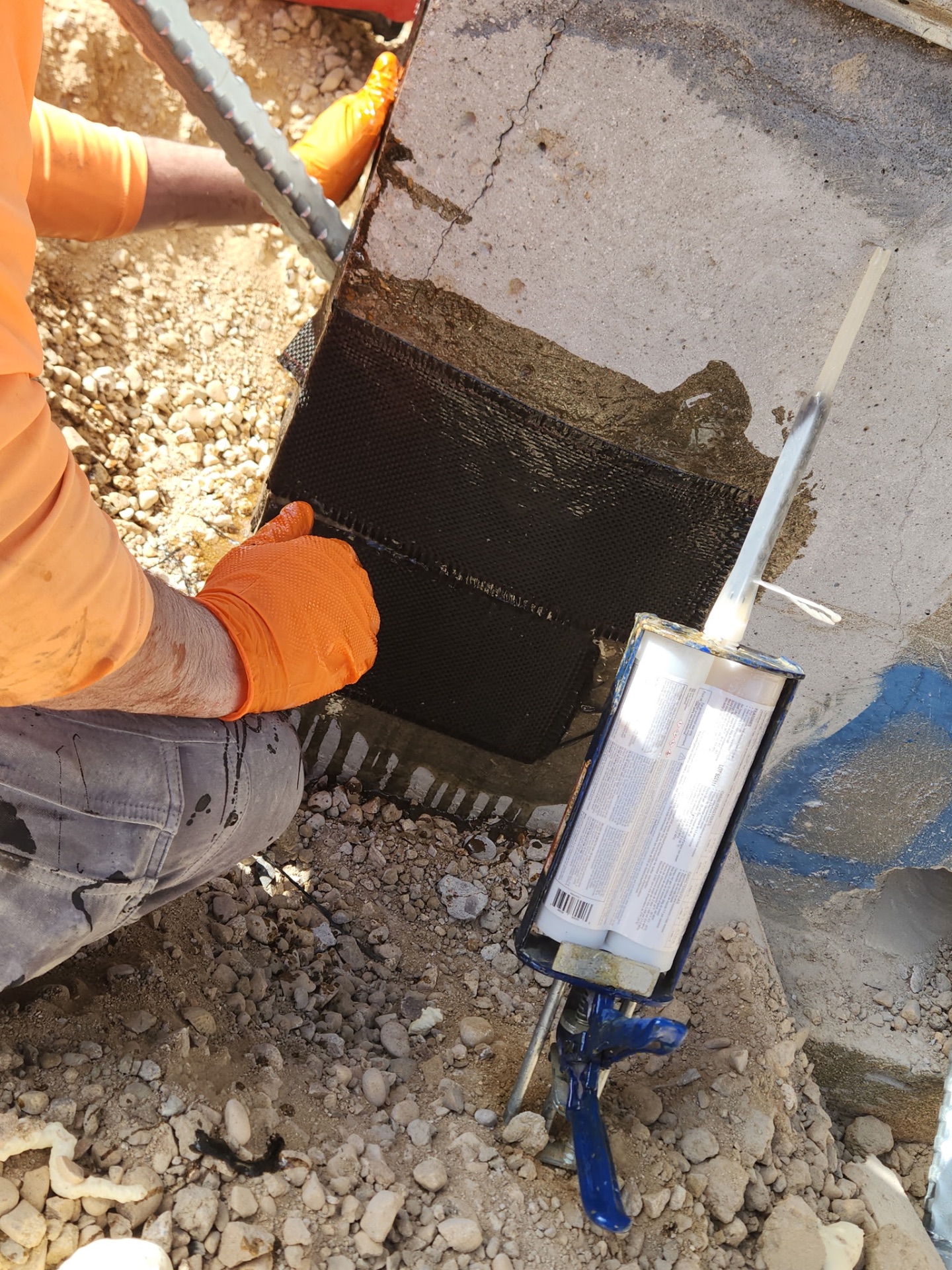 Crack repair using carbon fiber strap system.
