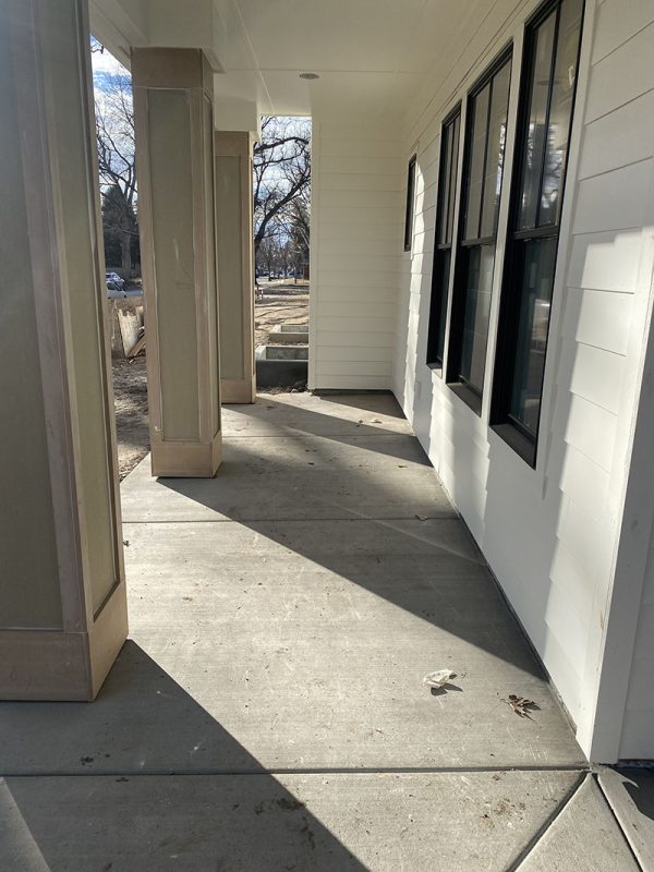 Covered front-porch walkway beside house columns