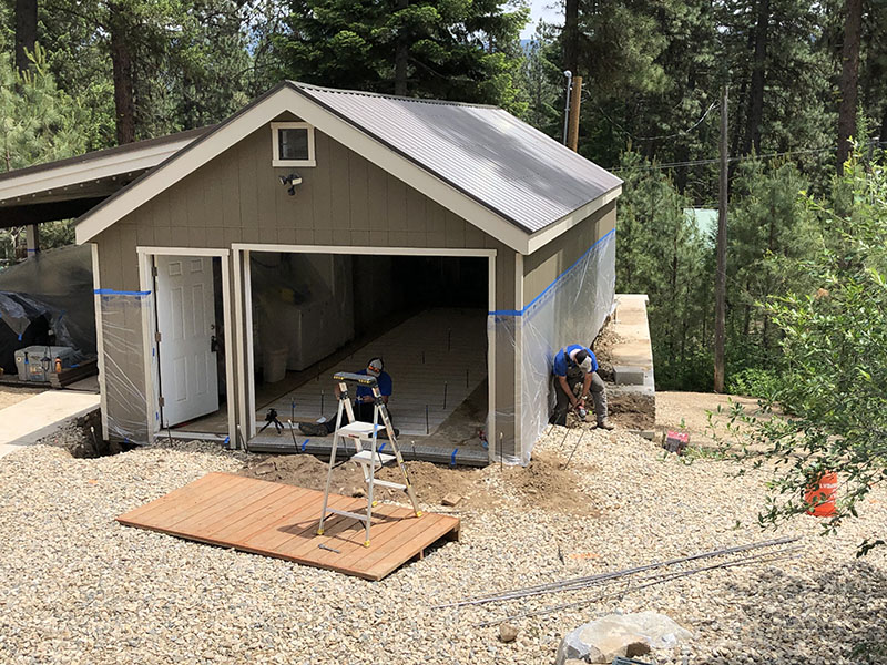 Shed with open garage bay during soil-stabilization work